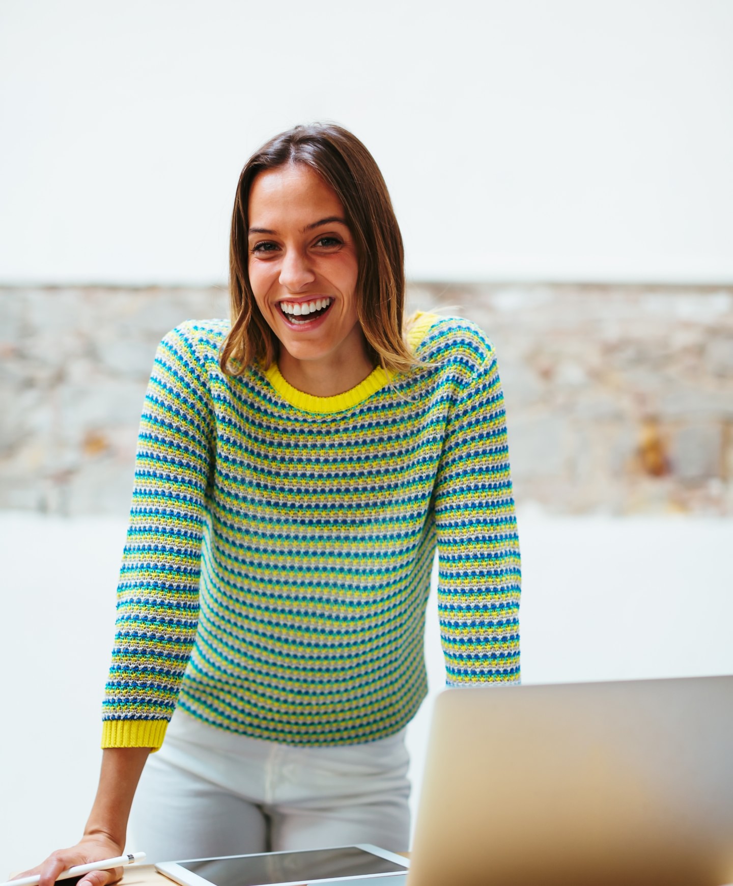 Photo of a smiling woman in a striped sweater
