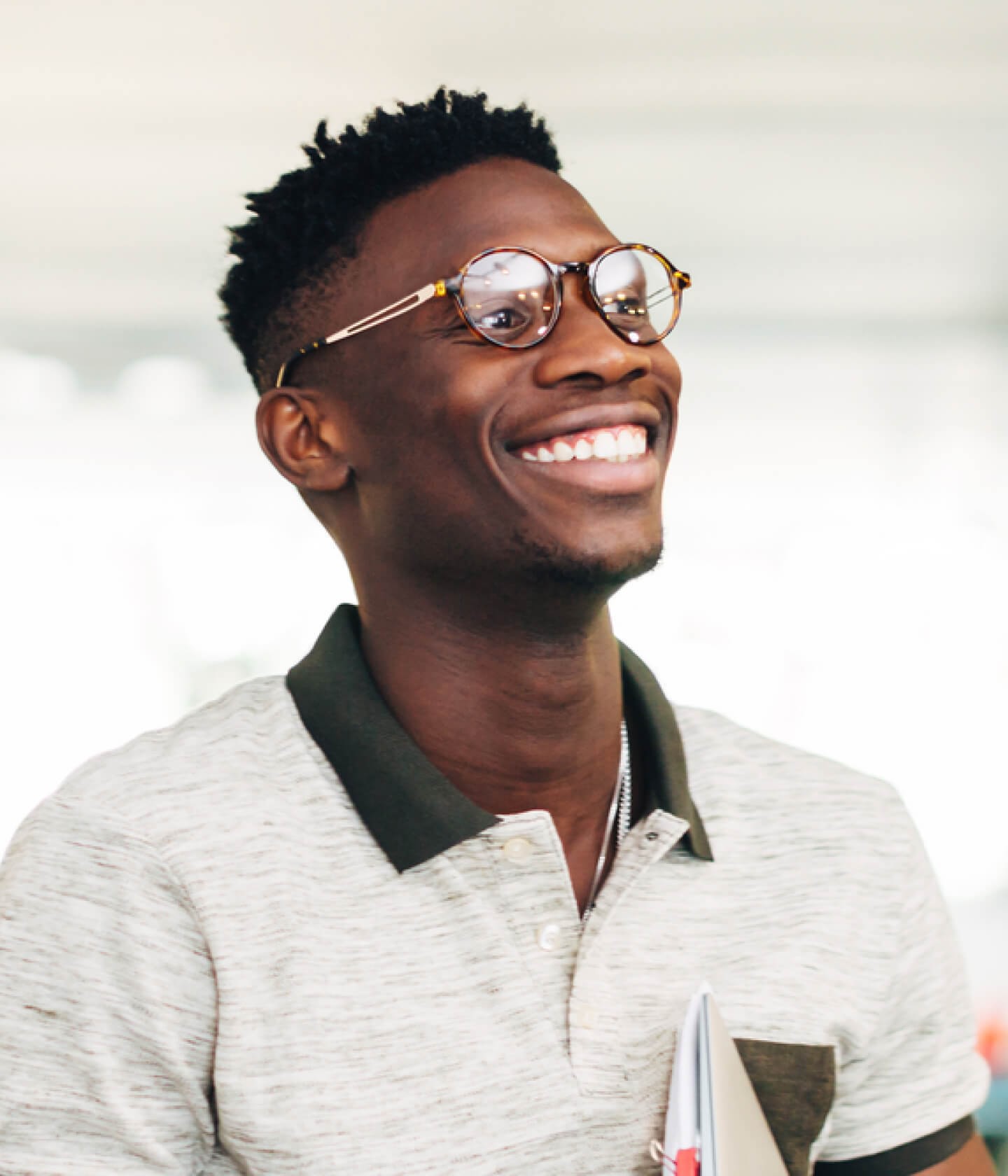 Photo of a young Black man with a big smile