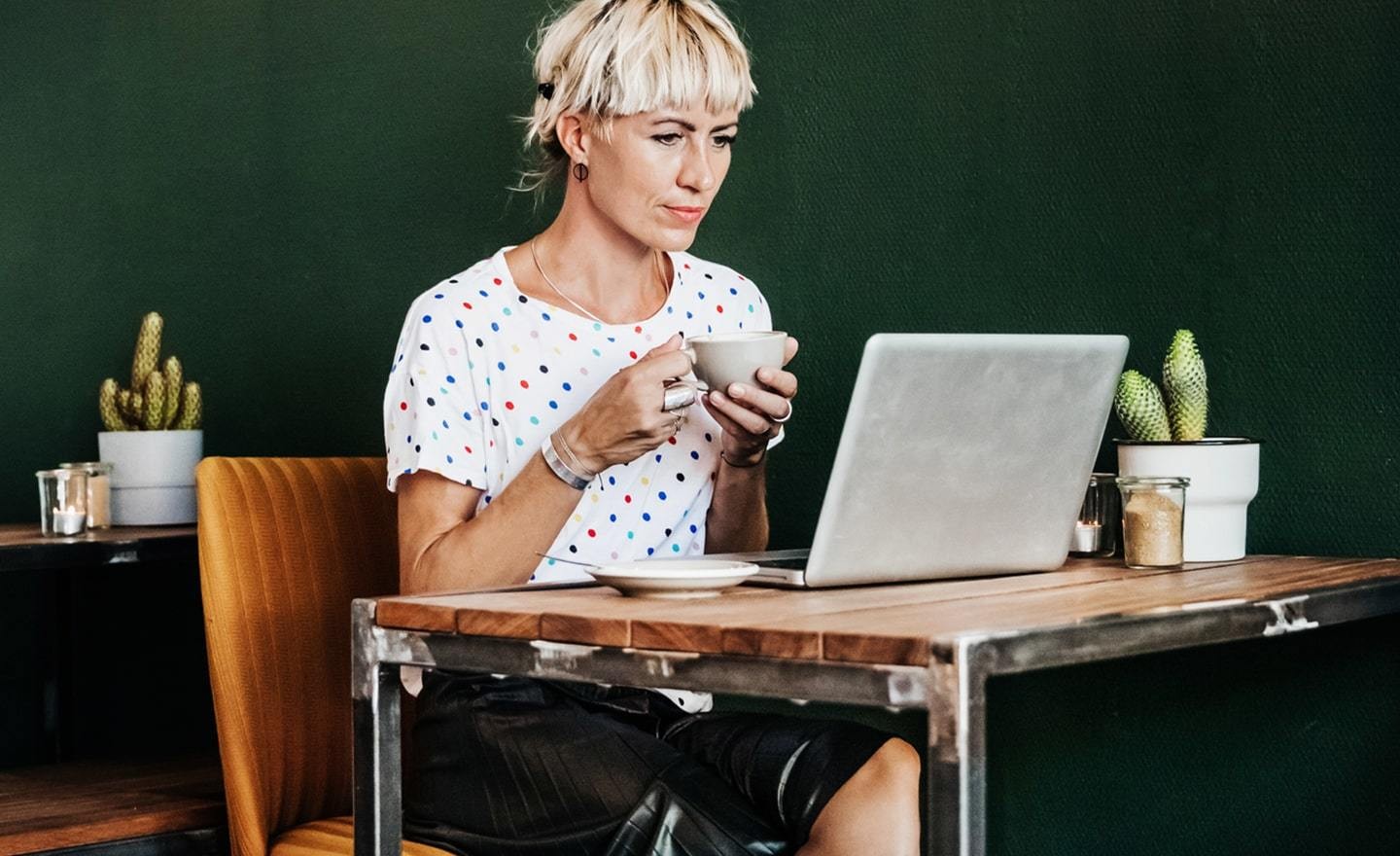 Woman working at a table with coffee r